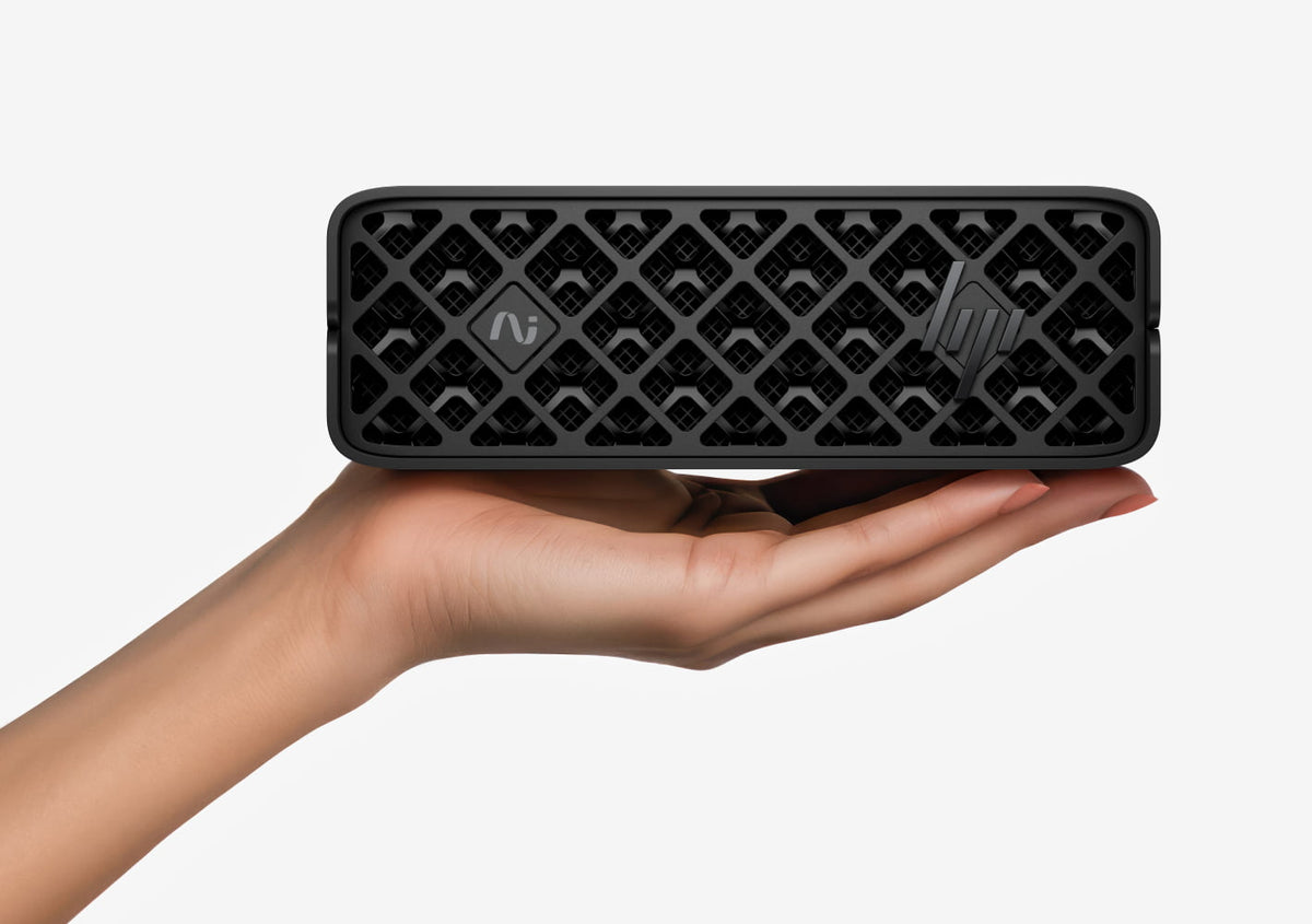 HP ZGX Nano G1n AI Station resting on an open palm, showing its compact size